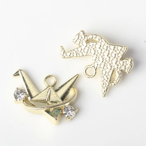 Detailed front and back views of golden origami crane charms with rhinestones for DIY jewelry