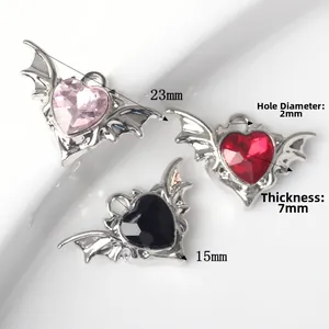 Set of gothic devil heart wing pendants with pink, red, and black zircon inlay