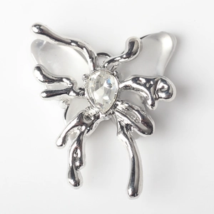 Detailed view of silver lava butterfly pendant with white resin wings and clear crystal