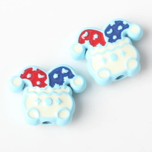 Detailed view of light blue clown hat charms for DIY jewelry making with star patterns