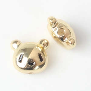 Detail of bear panda spacer beads with gold plating and central hole for jewelry DIY