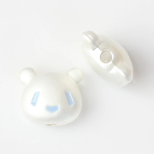 Macro view of cute panda beads with pearlescent finish for DIY jewelry making
