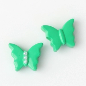 Detalle de cuentas de mariposa verdes con perlas para crear collares y joyas DIY