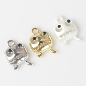 Hollow monster face pendants in gold, silver and pearl white with black rhinestone eyes
