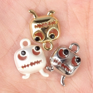 Three Halloween ghost face pendants in gold, silver, and black alloy with black rhinestones