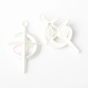 Detail of silver crescent moon cross charms with pink bead for DIY jewelry making