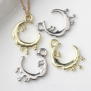 Macro detail of irregular melting moon pendants in gold and silver finish for DIY jewelry
