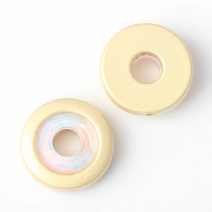 Macro detail of gold-plated spacer bead with iridescent inlay for DIY jewelry making