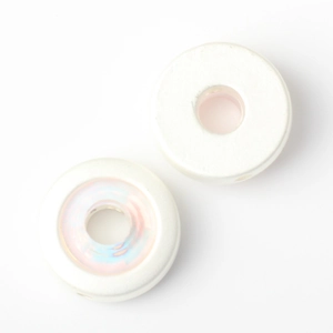 Macro view of white resin ring beads with iridescent inner luster for DIY jewelry