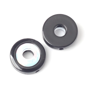 Macro detail of black circular spacer beads with iridescent inlay for DIY jewelry crafts