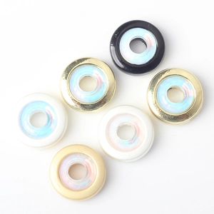 Flat lay of minimalist alloy beads with iridescent centers for DIY jewelry making