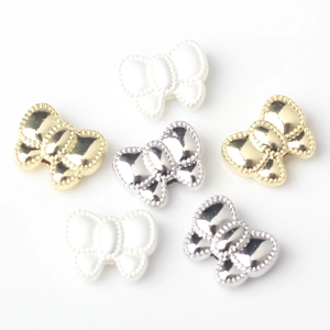 Bow-shaped DIY alloy beads in gold, silver, and pearl finishes with beaded edge detailing