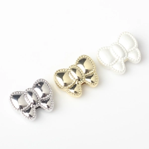 Three bow-shaped alloy bead charms in gold, silver and pearl white for DIY jewelry making