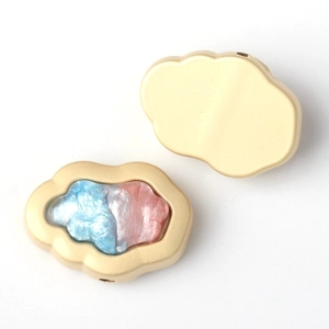 Detailed macro view of matte gold cloud charm with blue and pink pearlescent resin inlay