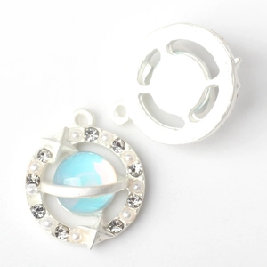 Close-up of alloy planet pendant charm with blue opal, pearls and rhinestones detail