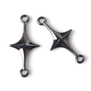 Close-up of dual-loop cross star jewelry connectors in polished black chrome alloy