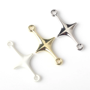Detailed view of alloy cross star connector charms in silver, gold, and matte white finishes