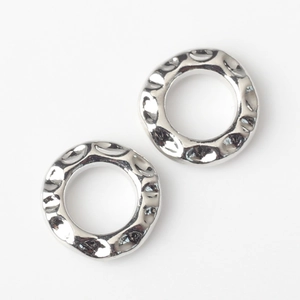 Macro detail of silver geometric rings with irregular hammered texture for DIY jewelry