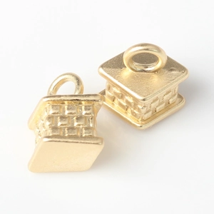 Detailed view of 3D geometric gold cube charms with intricate woven texture and top loops
