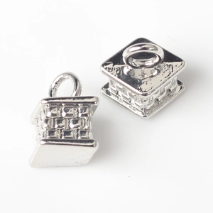 Close-up of silver geometric square pendants with textured woven pattern for jewelry