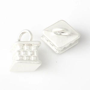 Macro detail of silver square pendants featuring a 3D woven grid embossed texture