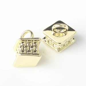 Macro shot of 3D geometric gold cube charms with intricate mesh texture for DIY jewelry
