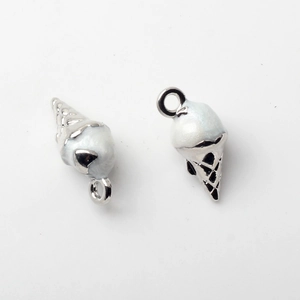 Macro shot of silver zinc alloy ice cream cone charms with white enamel glitter finish