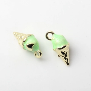 Macro detail of gold plated ice cream pendants with mint green enamel and heart pattern