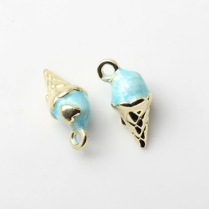 Detailed macro view of two blue enamel ice cream cone pendants with gold metal bases