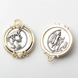 Detailed macro view of two-tone coin charms with relief portrait and faux pearls