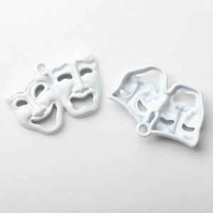Macro detail of alloy white enamel comedy and tragedy drama mask charms for jewelry DIY