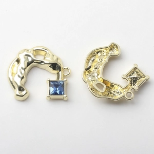 Detailed view of alloy semi-circle C-shape pendant with blue crystal for DIY jewelry