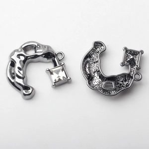 Macro shot of gunmetal alloy U-shape pendant with square crystal for DIY jewelry