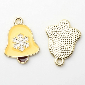 Macro detail of colorful Christmas bell pendants showing enamel snowflake and metal back