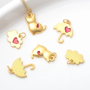 Vintage gold alloy pendants featuring cat, umbrella, and cloud shapes with red heart details