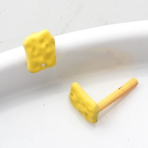 Detail showing irregular yellow geometric alloy earring components for DIY jewelry making