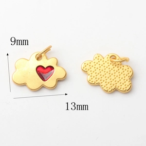 Macro detail of cloud charm with red heart and dotted texture for DIY jewelry making