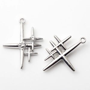 Macro shot of silver-plated star pendants with crystal inlay and mounting rings