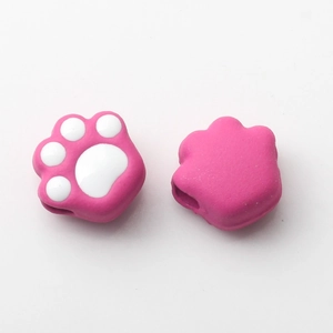 Detail view of pink and white enamel cat paw beads for DIY jewelry and accessories