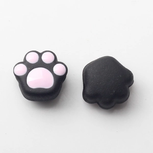 Close-up of black and pink cat paw joystick thumb grips for game controllers