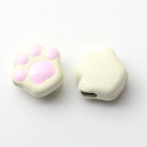 Detail of white and pink cat paw silicone beads with back holes for DIY jewelry