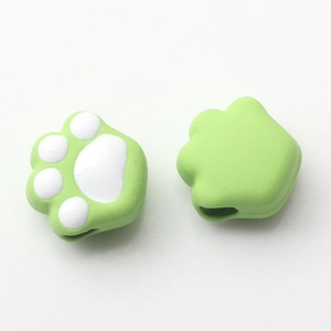 Detail of light green cat paw silicone thumb grip caps for gaming console joysticks