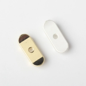 Close-up of gold polished and silver matte oval alloy skateboard pendant connectors
