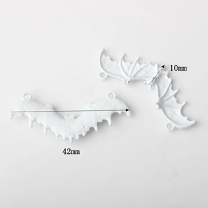 Detail of white bat wing alloy pendants with dimensions 42mm by 10mm for DIY jewelry
