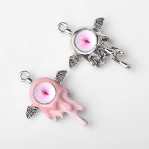 Detail of alloy devil eye wing charms in silver and pink enamel for DIY jewelry making