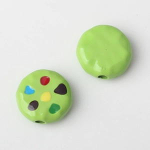 Detailed view of 10mm green alloy bean beads with colorful enamel dots for DIY jewelry