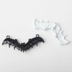 Pair of minimalist alloy bat charms in black and white enamel for DIY jewelry making