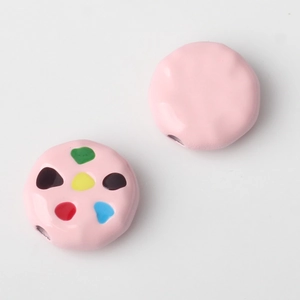 Macro shot of colorful dotted and pink alloy beads for DIY jewelry making