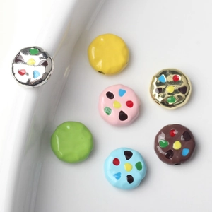 Macro shot of colorful enamel cookie-shaped alloy beads for DIY jewelry making