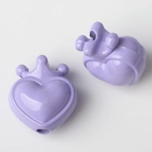 Macro shot of purple crown heart pendant with threading hole for DIY jewelry making